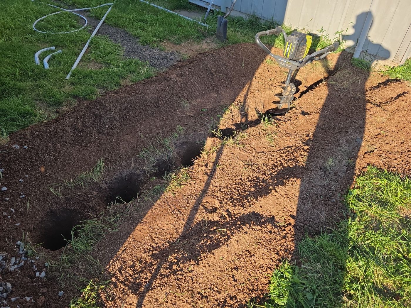 Trenching for underground plumbing and conduit install